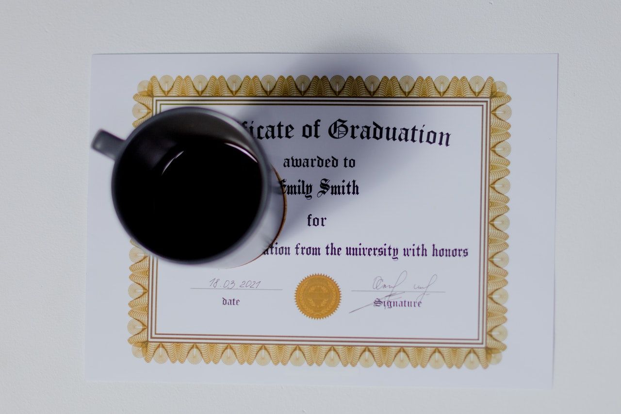 certificate of graduation with a cup of coffee on it