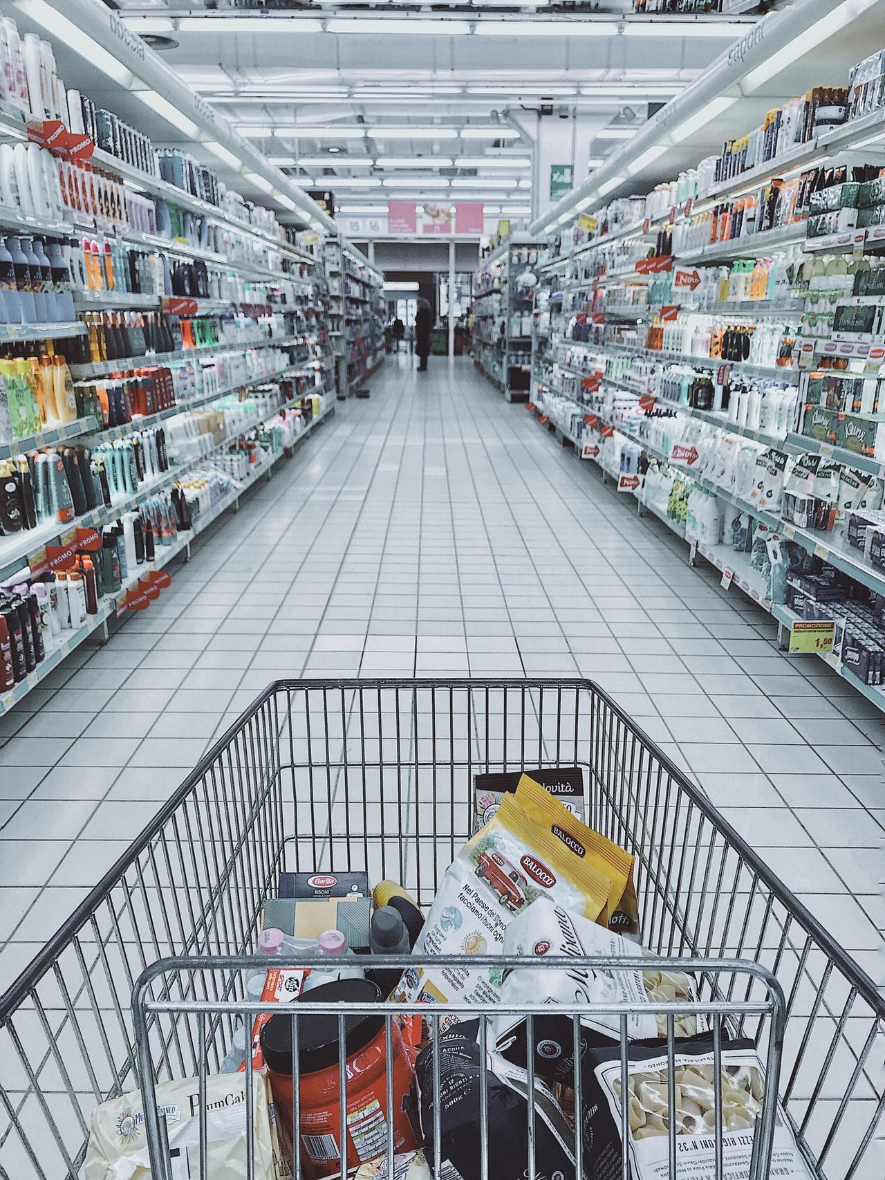 Image of a full shopping cart in a store aisle